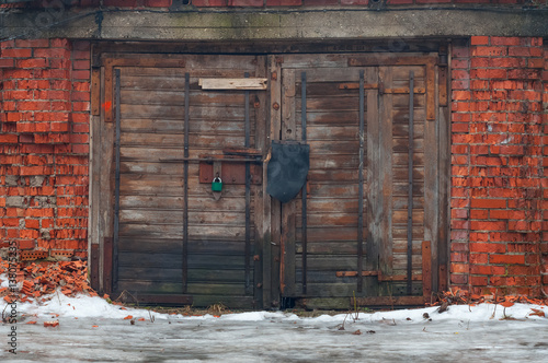 Bild auf Leinwand Old garage doors and tumbledown brick walls.