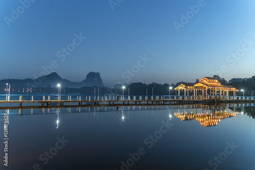 Myanmar, Hpa-an, Illuminated pier at Kan Thar Yar Lake at blue hour photo
