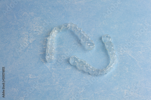 Clear Invisible Teeth Aligner on a blue background