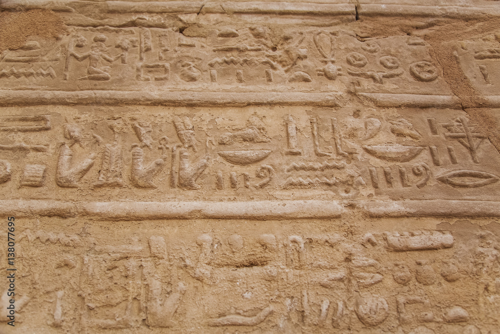 Close up of hieroglyphs cutted in walls of ancient Karnak Temple in Luxor, Egypt. Photo shot in 2017. Horizontal color photography. Close up of hieroglyphs cutted in walls of ancient Karnak Temple in Luxor, Egypt. Photo shot in 2017. Horizontal color photography.
