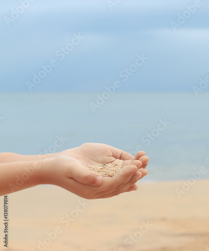 sand in hand of a child © Win Nondakowit
