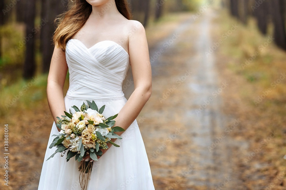 Wedding bouquet in the hands of the bride Wedding bouquet in the hands of the bride