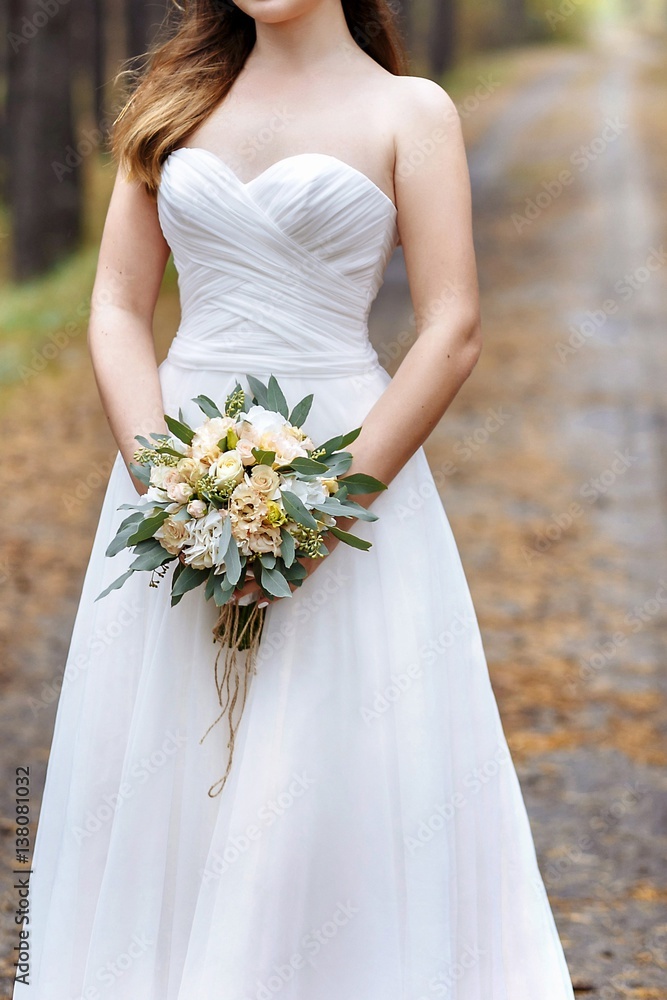 Wedding bouquet in the hands of the bride Wedding bouquet in the hands of the bride