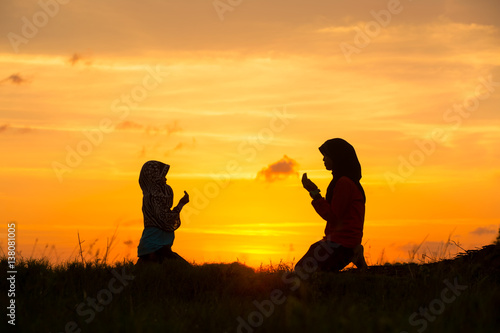 Muslim girls silhouette blurred background,Silhouettes,the light of faith, hope, faith, supplication,Hand of Muslim people praying with mosque interior background,