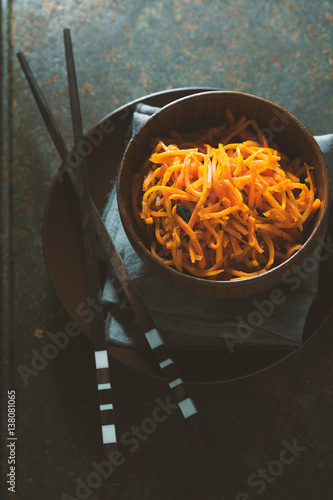 Carrots in Korean and spices in a bowl on wooden boards photo