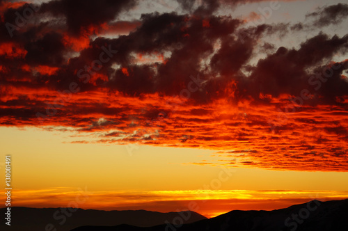 Colorful fiery sunset over the mountains © Mila Che