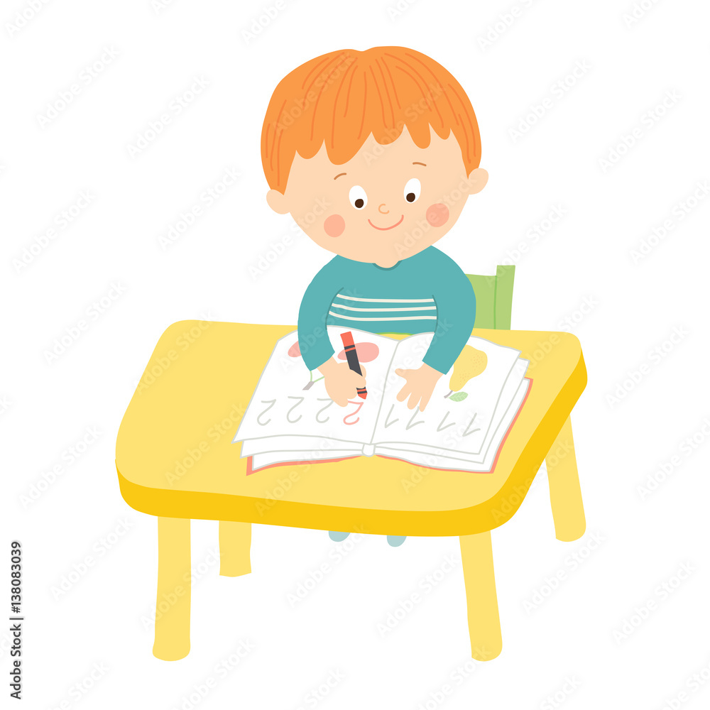 Cute school boy writing at desk in classroom Cute school boy writing at desk in classroom