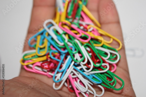 Colorful paperclips in hand