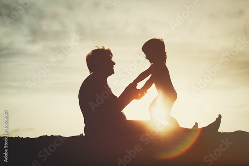 silhouette of grandmother and little granddaughter play at sunset