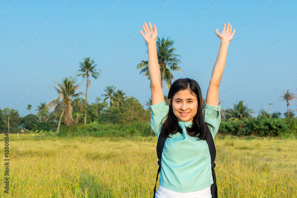 Young woman traveling among rice fields with backpack Young woman traveling among rice fields with backpack