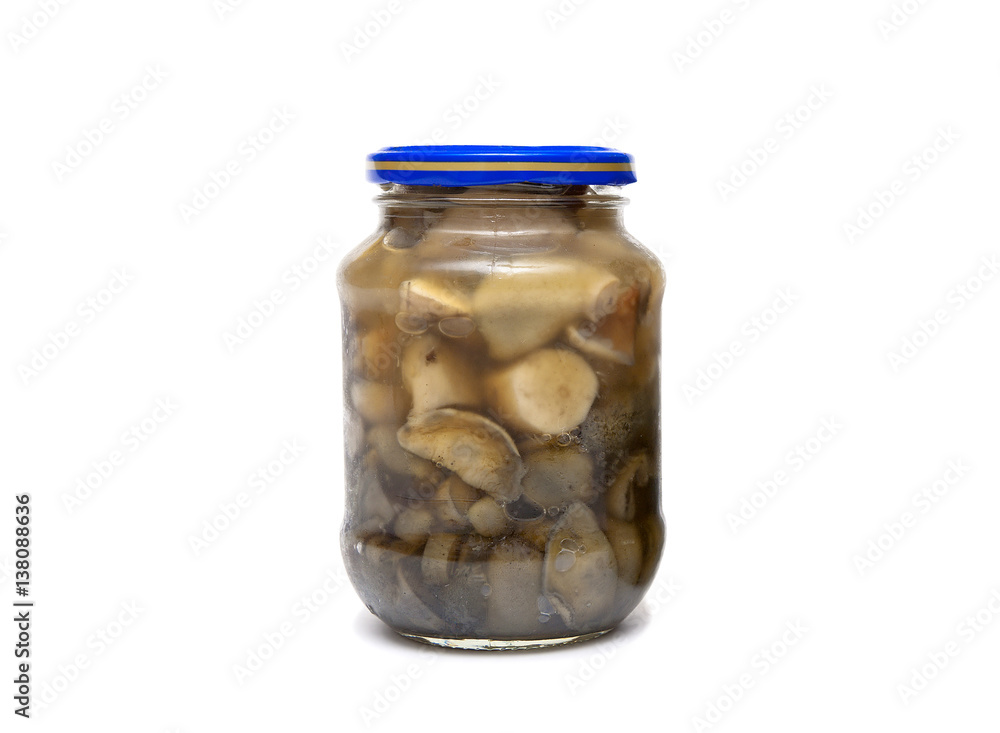 marinated wild mushrooms in a jar on a white background marinated wild mushrooms in a jar on a white background