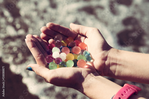 Colorful balls in hands orbeez