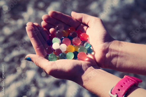 Colorful balls in hands orbeez
