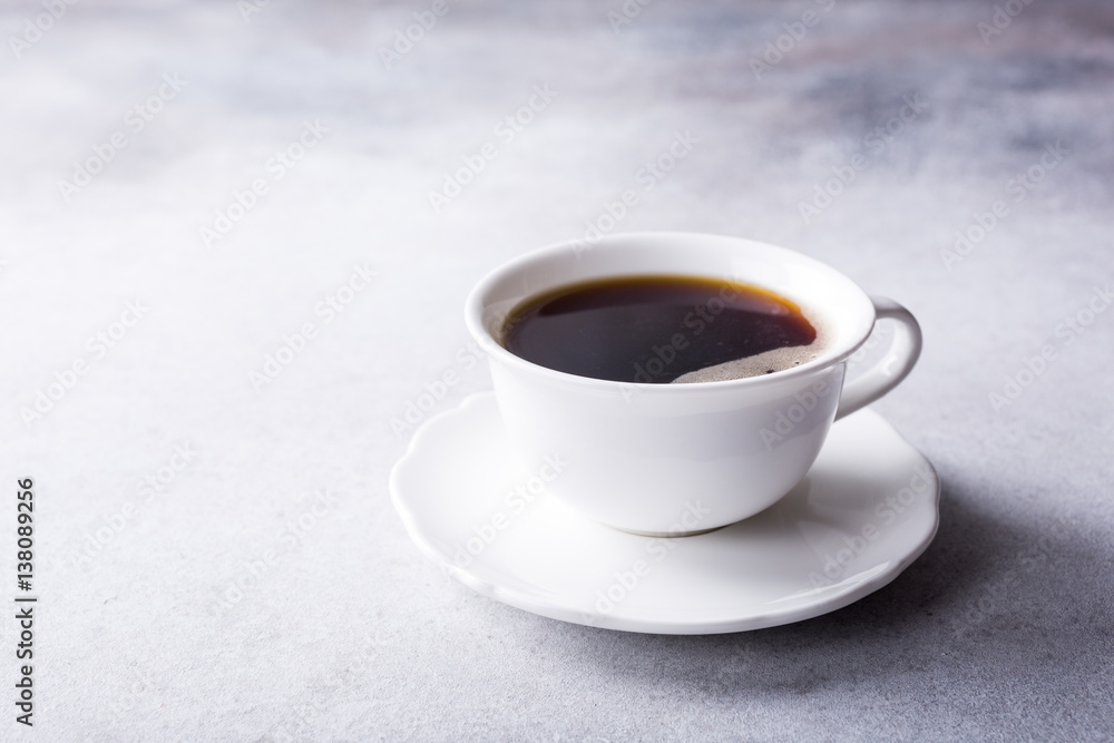 White cup of coffee with amaretti cookies on light gray background with copy space. White cup of coffee with amaretti cookies on light gray background with copy space.