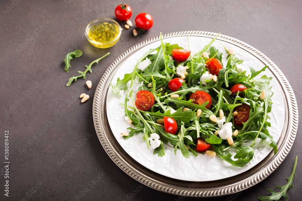 fresh vegetable salad with rucola, tomatos and goat cheese. Healthy food concept. Copy space. fresh vegetable salad with rucola, tomatos and goat cheese. Healthy food concept. Copy space.