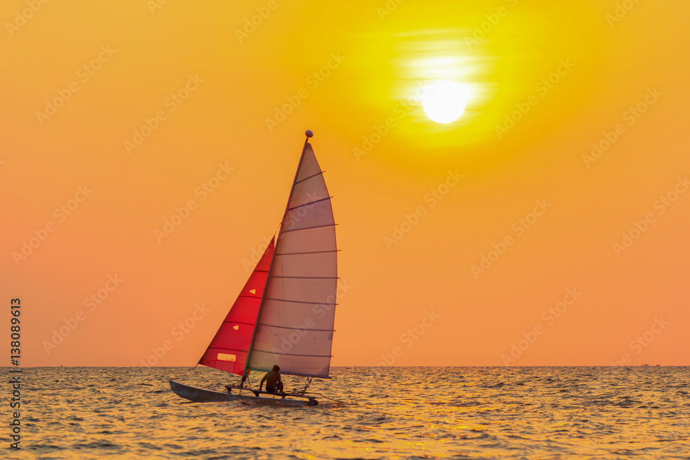 sailing boat with orange sky