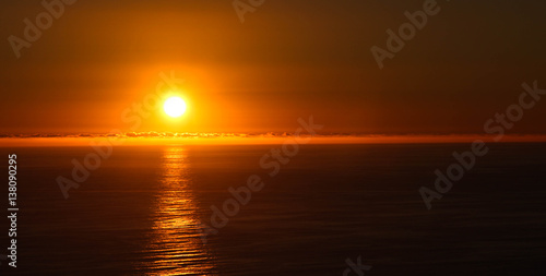 Sun setting over ocean