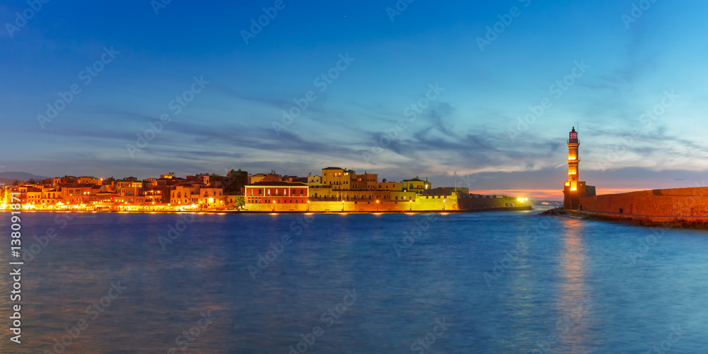 Panorama venetian harbour waterfront and Lighthouse in old harbour of Chania during twilight blue hour, Crete, Greece