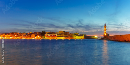 Panorama venetian harbour waterfront and Lighthouse in old harbour of Chania during twilight blue hour, Crete, Greece