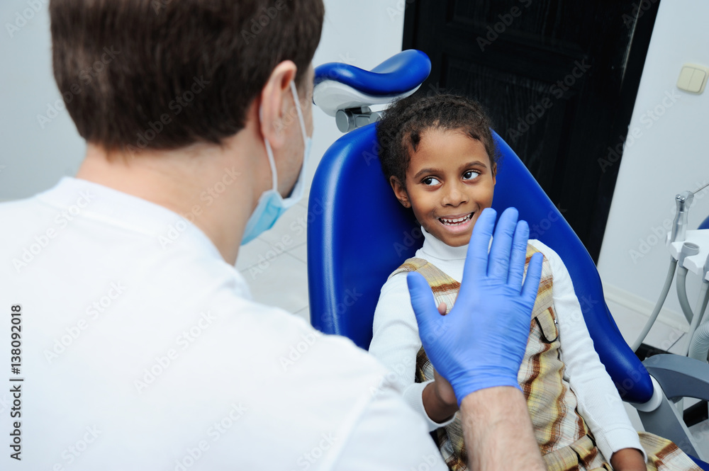 girl with black skin in the dental chair girl with black skin in the dental chair