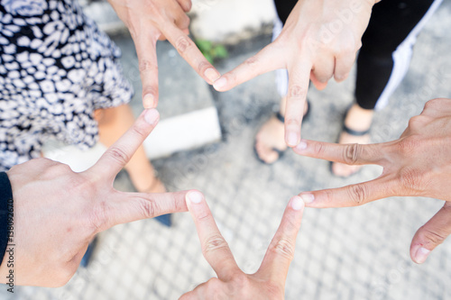 Posting finger of group of people in v shape, victory or star to represent victory, fight, unity, collaborative, teamwork.