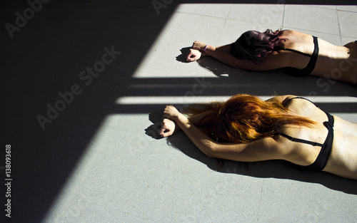 Women on the floor with hands tied