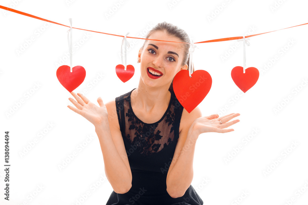 young cheerful brunette lady with red heart in studio smiling on camera isolated on white background. Valentines Day concept. young cheerful brunette lady with red heart in studio smiling on camera isolated on white background. Valentines Day concept.
