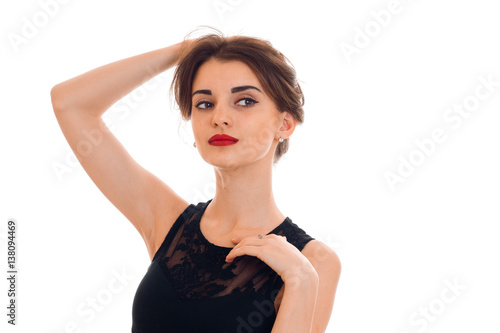 close up portrait of young serious lady with red lips posing and looking aside isolated on white background © ponomarencko