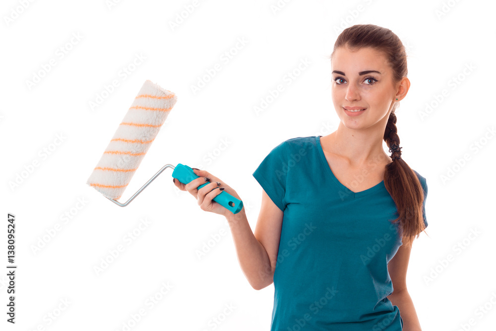 young beautiful brunette woman builder in uniform with paint roller in hands make reovations and posing on camera isolated on white background young beautiful brunette woman builder in uniform with paint roller in hands make reovations and posing on camera isolated on white background