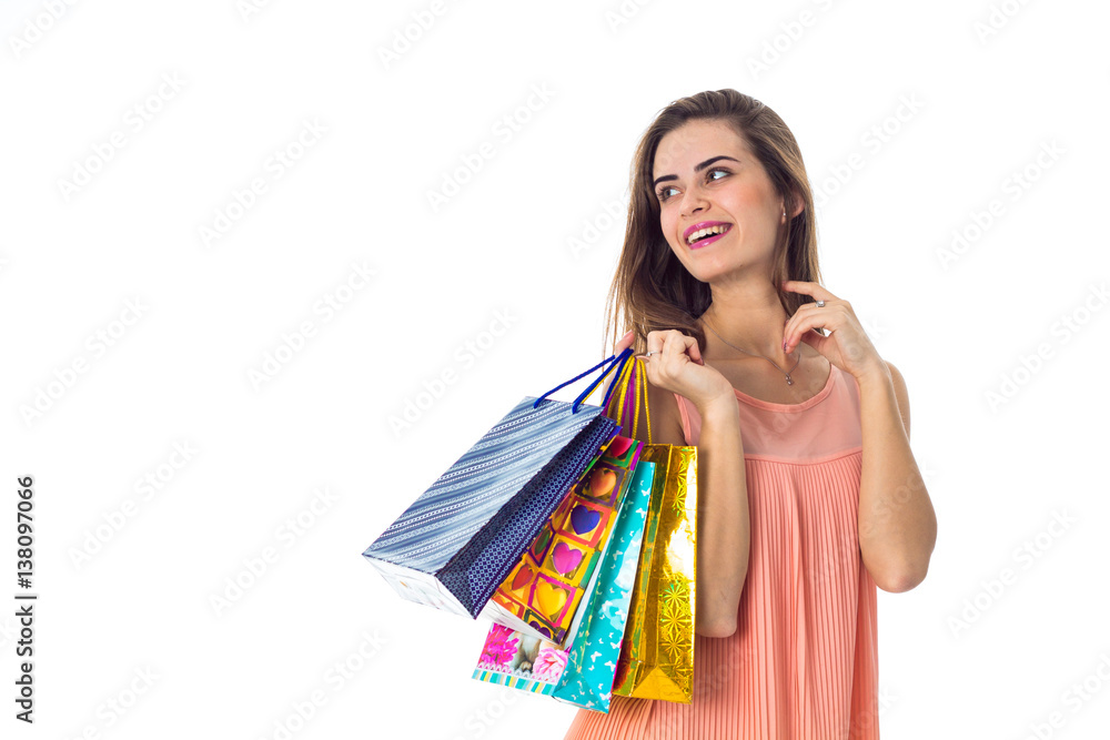 young girl looks away and keeps the color packages isolated on white background young girl looks away and keeps the color packages isolated on white background