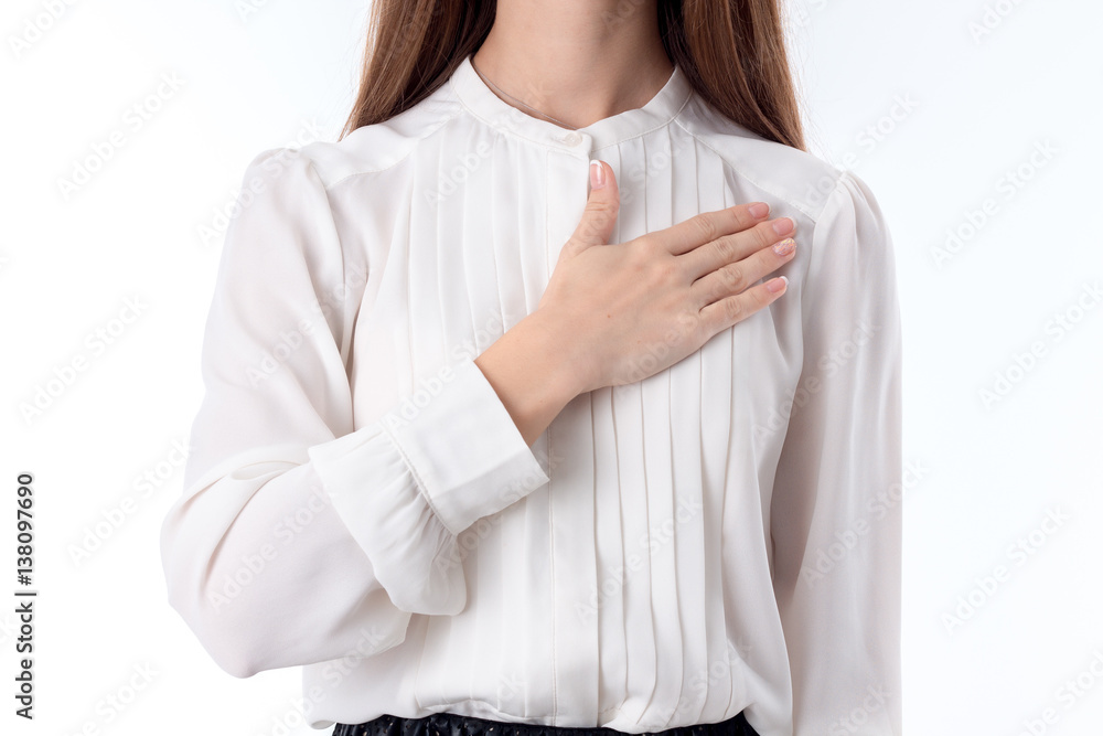 girl in shirt keeps his hand on the chest close-up