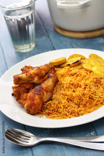 jollof rice with chicken and fried plantain, west african cuisine photo