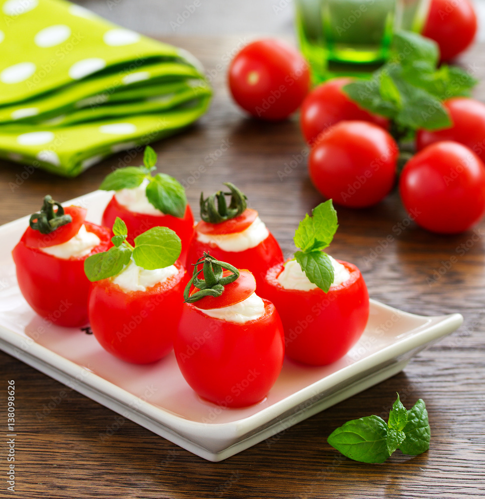 Cherry tomatoes stuffed with yogurt with mint. Cherry tomatoes stuffed with yogurt with mint.