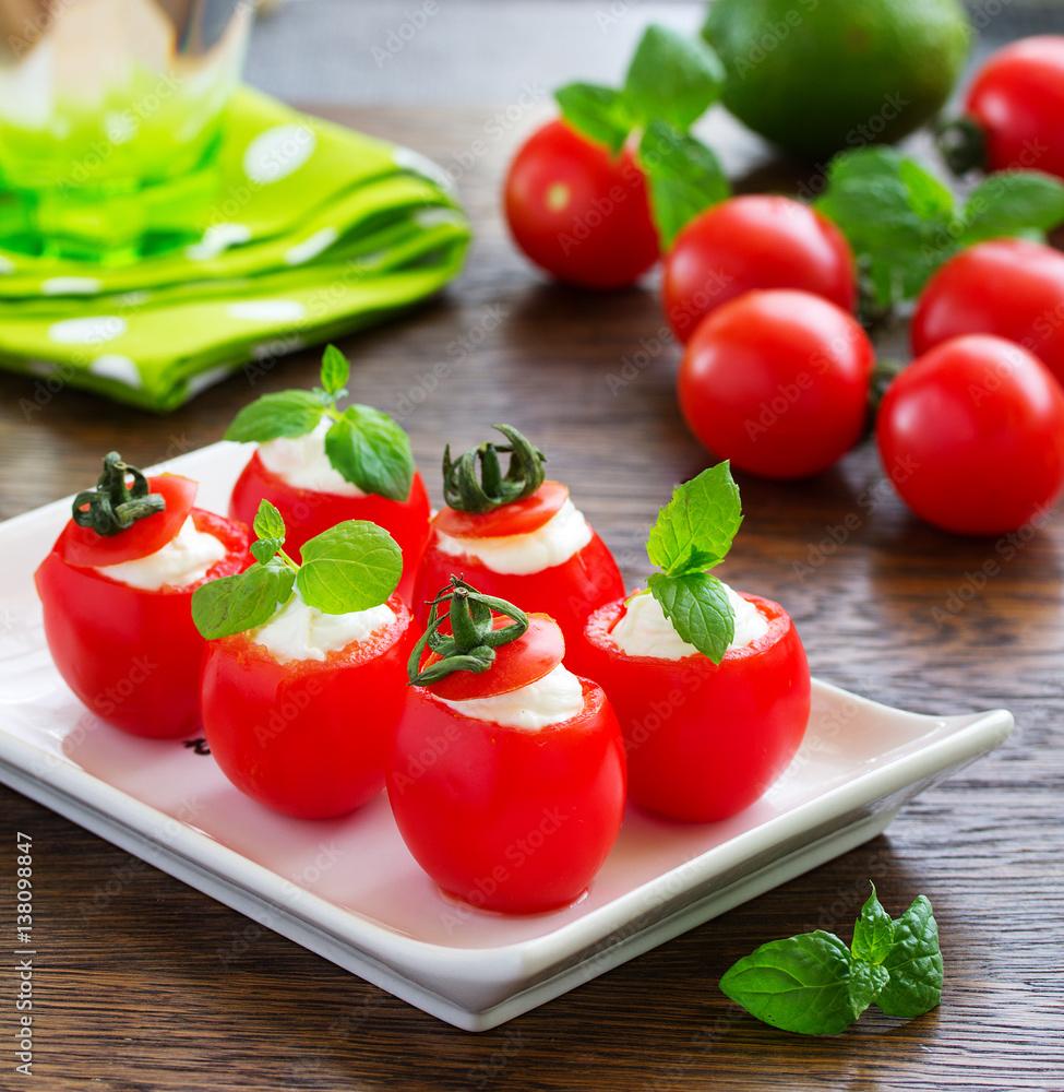 Cherry tomatoes stuffed with yogurt with mint. Cherry tomatoes stuffed with yogurt with mint.