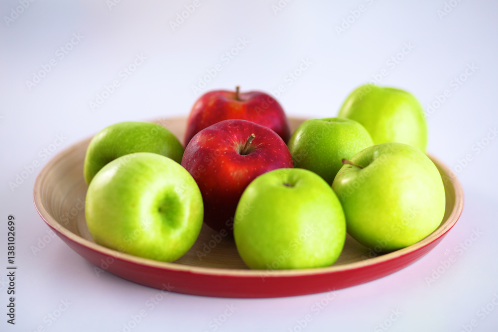 Still life arrangement of apples on a wooden platter Still life arrangement of apples on a wooden platter