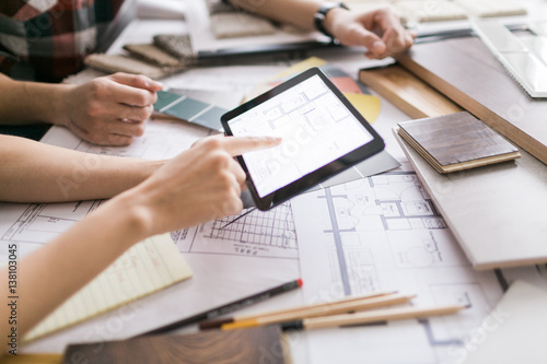 A young couple reviews floorplan on a tablet
