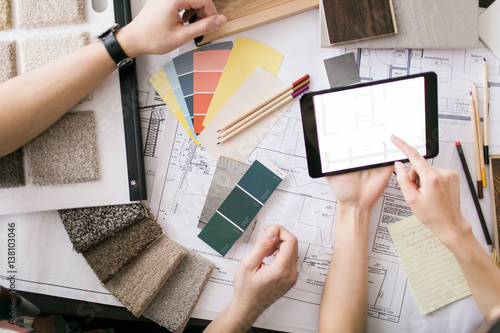 A young couple reviews floorplan on a tablet