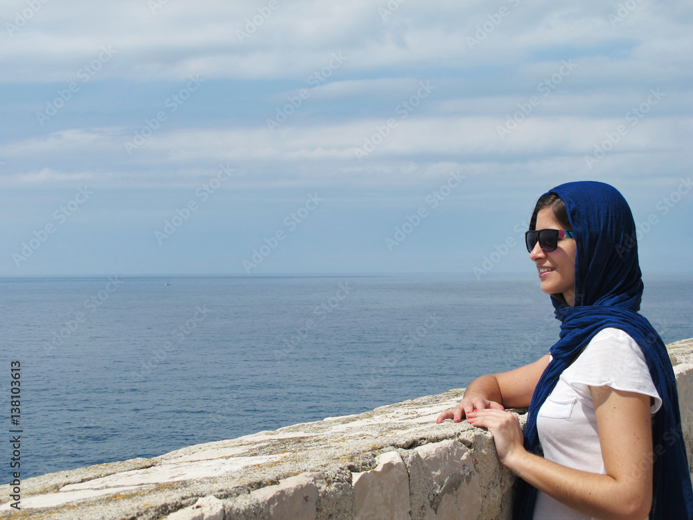 tourist arabic woman sightseeing at Dubrovnik ancient wall in Croatia