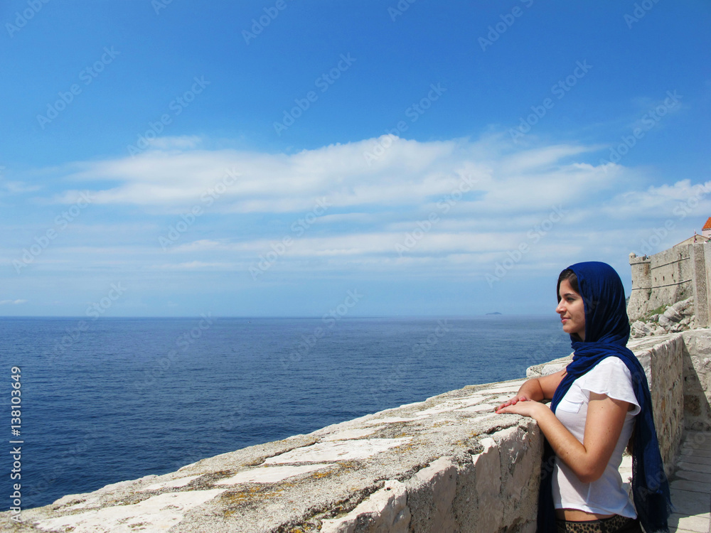 tourist woman sightseeing at Dubrovnik ancient wall in Croatia