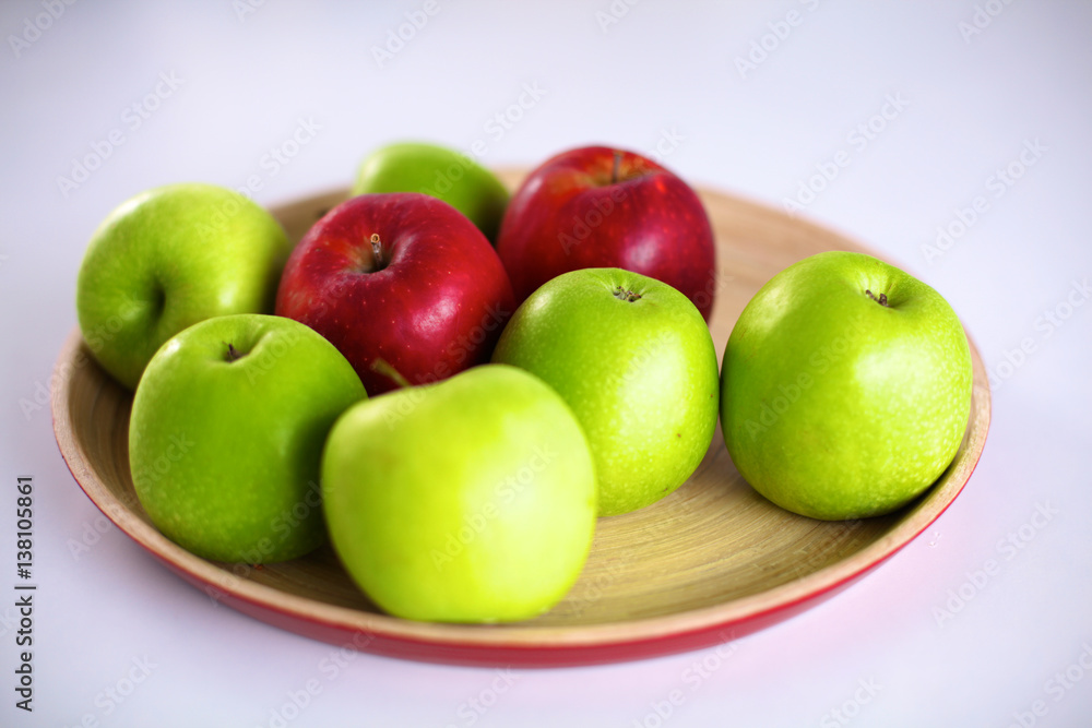 Still life arrangement of apples on a wooden platter Still life arrangement of apples on a wooden platter