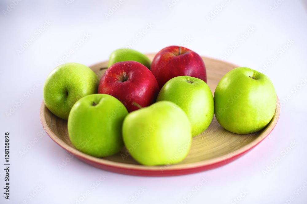 Still life arrangement of apples on a wooden platter Still life arrangement of apples on a wooden platter