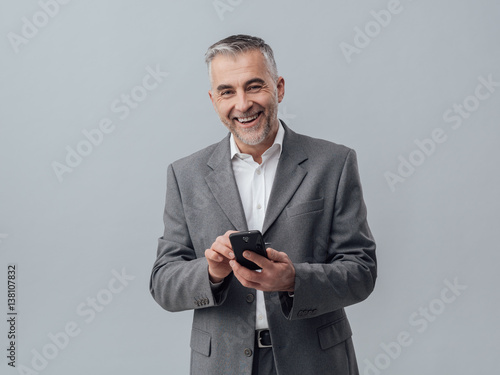 Businessman texting with his smartphone