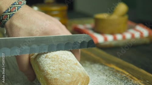 Cut slice of bread in slow motion, close up