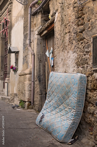 Old torn mattress thrown into the street. Palermo. Sicily