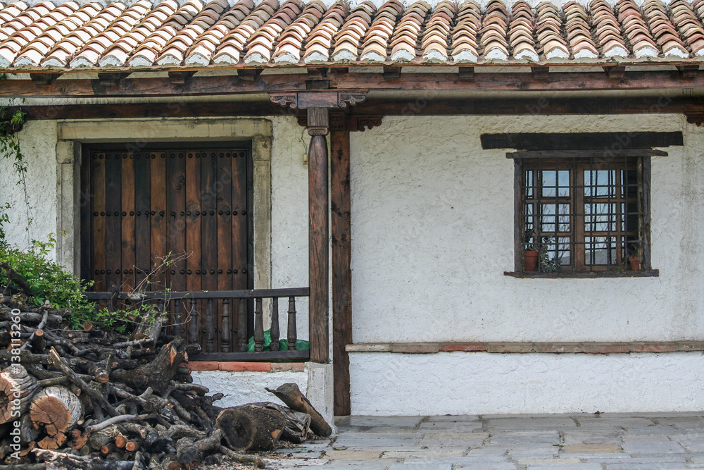 Fachada con tejado detejas, puerta y ventana de hierro y madera Stock Photo  | Adobe Stock