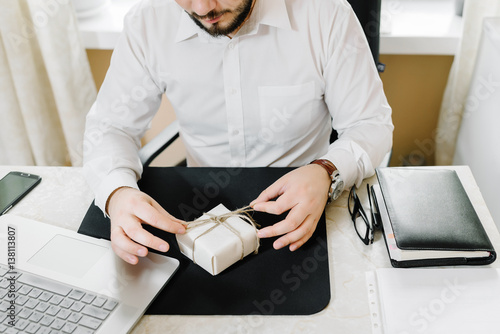 Business man with gifts businessman offering a gift to you