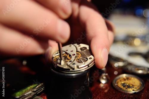 clockwork close up in the hands of a watchmaker photo