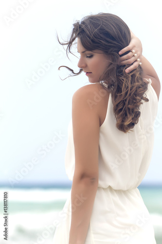 Portrait of a young attractive and beautiful woman in front of the beach. Close up.