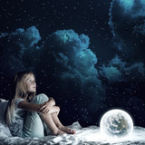 Girl in her bed and glowing globe