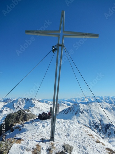summit cross in winter austrian alps © luciezr